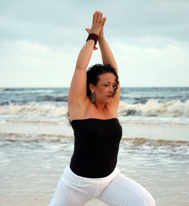 Rachel Morrison of Mindful Movement DC doing yoga at the beach