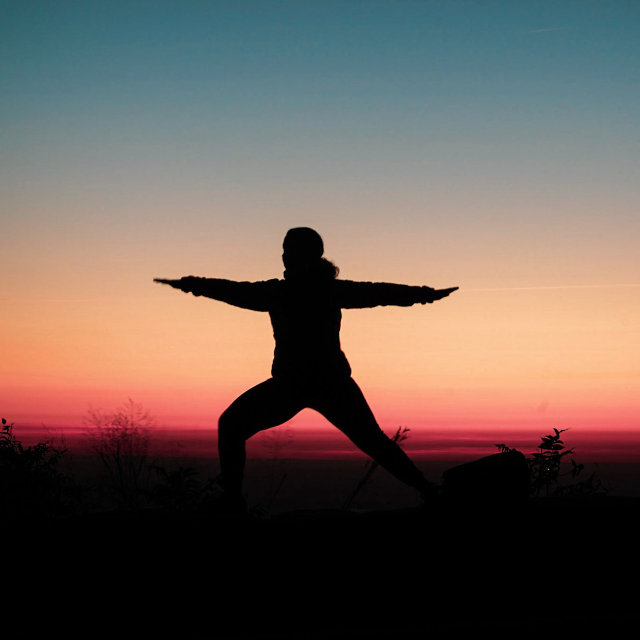 Rachel Morrison of Mindful Movement DC doing yoga at sunset